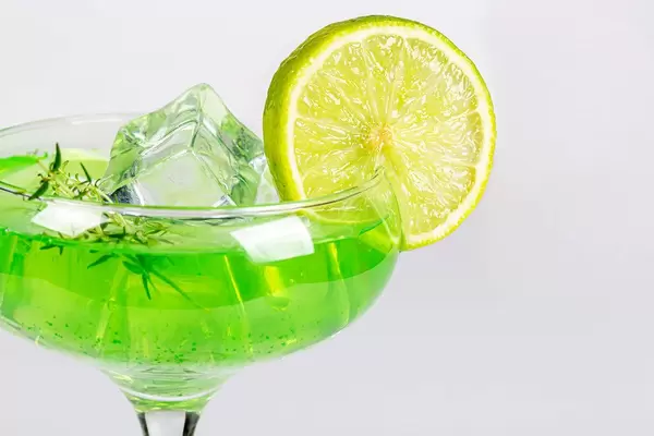Cocktail with ice cubes, fresh thyme and lime