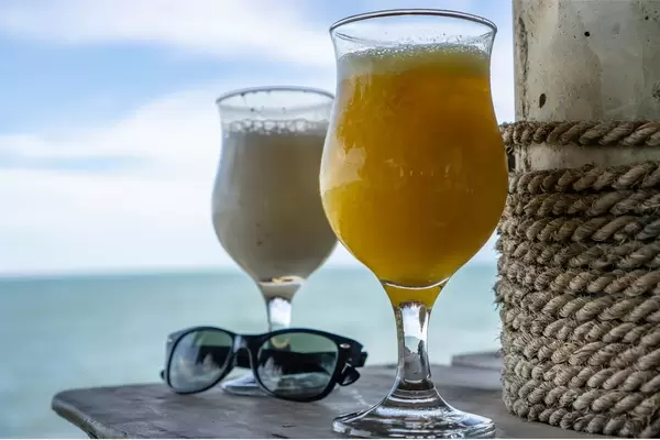 Cocktails and Sunglasses on a Table with Seaview in the Background  Flip 2019