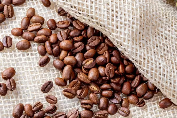 Coffee beans background close up with burlap