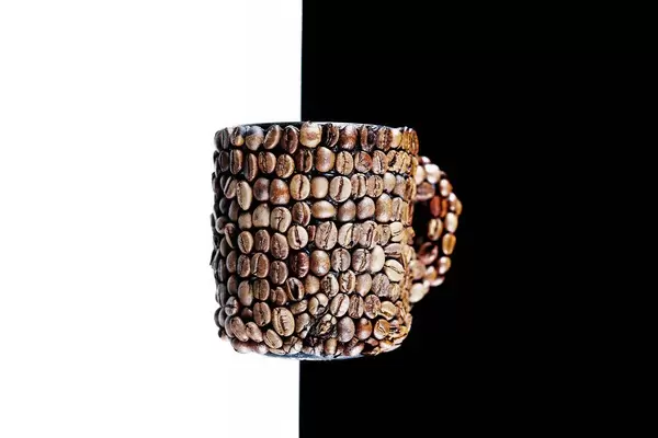 Coffee beans cup, background split in black and white (Flip 2019)