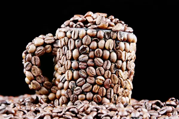 Coffee beans in a cup, black background (Flip 2019)