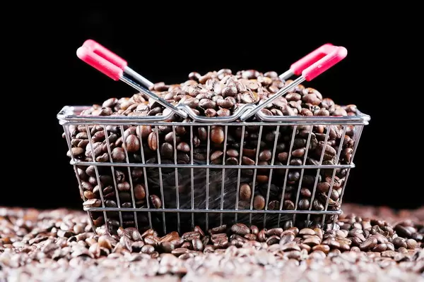 Coffee beans in a shopping basket, black background