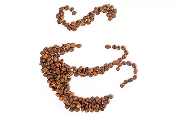 Coffee cup made from coffee beans on white background