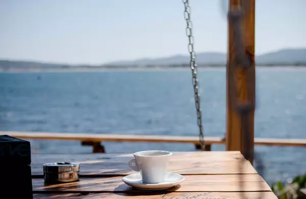 coffee cup on the beach background