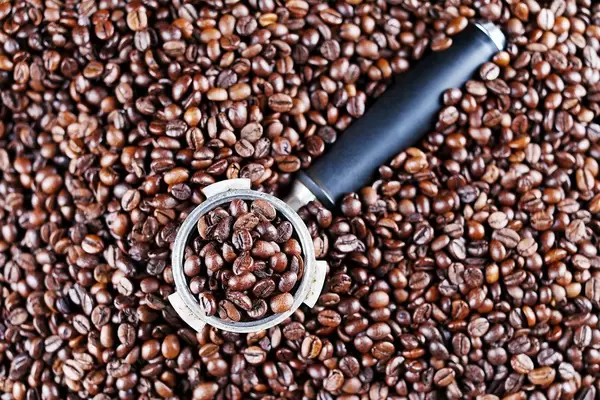 Coffee maker sump, coffee beans background