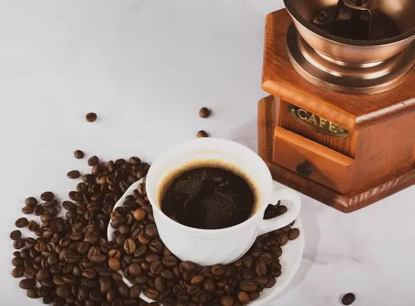 Coffee mill and a cup of coffee