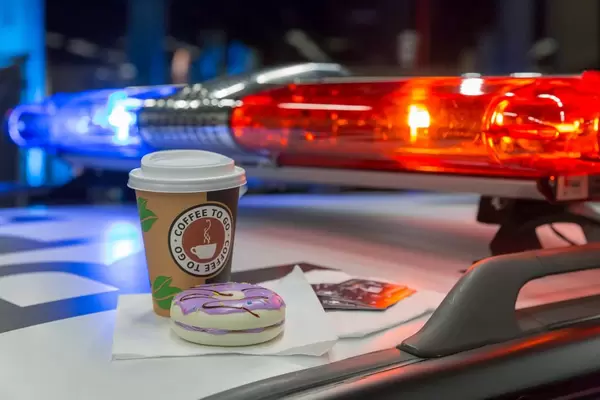 Coffee to go and donuts on a police car