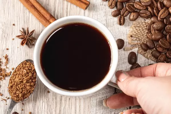 Coffee with cinnamon, anise and grains on wooden background, top view (Flip 2019)