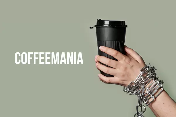 Coffeemania concept with chained person hands holding a cup of coffee