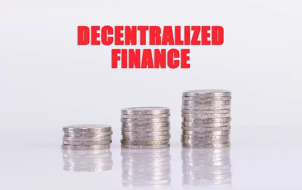 Coin stacks with Decentralized Finance text on white background