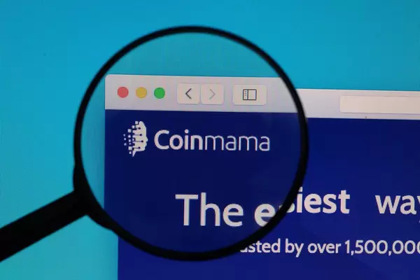 Coinmama logo under magnifying glass