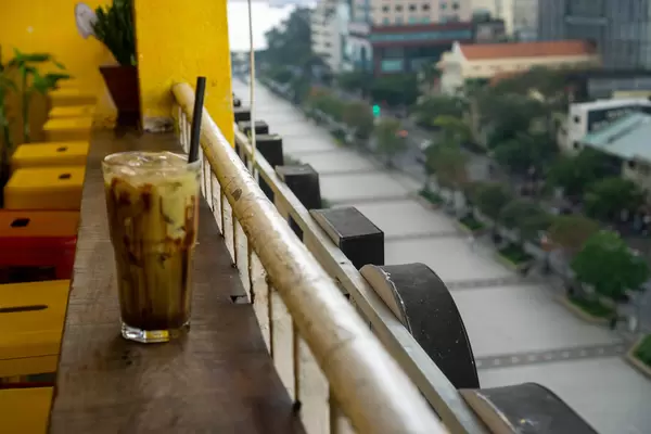 Cold Chocolate Drink with Ice Cubes in a Cocktail Glass on the Balcony of a Coffee Shop at The Cafe Apartment Building in Saigon, Vietnam