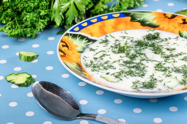 Cold vegetable soup okroshka with fresh herbs