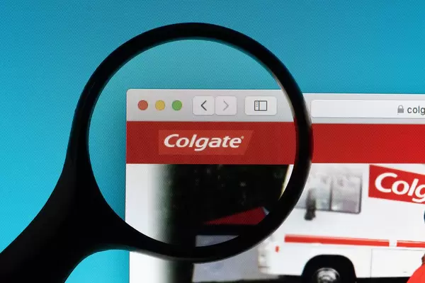 Colgate logo under magnifying glass
