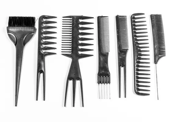Collection of black combs on white background. Top view
