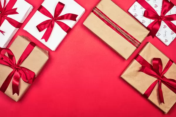 Collection of different handmade gift boxes on red