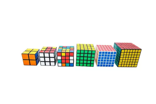 Collection of different Rubik's cubes on white background