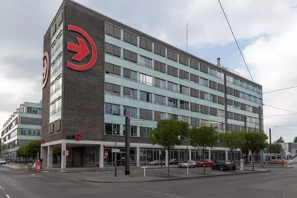 Cologne transportation company:  E-Charging station in front of KVB office building in Germany with large, red logo