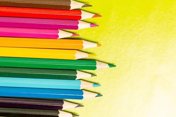 Color pencils on a yellow background
