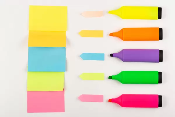 Colored open markers with multicolored paper stickers, concept for notes, plans