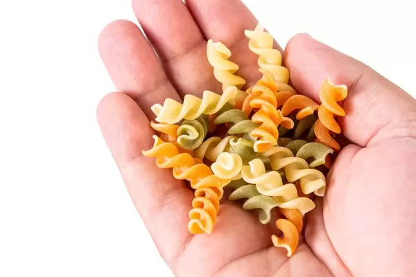 Colored Pasta in the hand with copy space (Flip 2019)