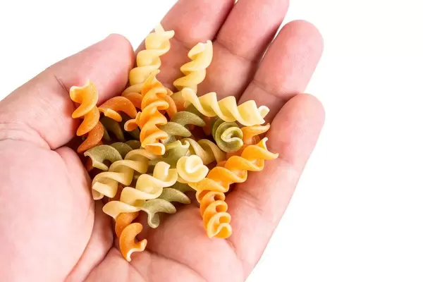 Colored Pasta in the hand with copy space