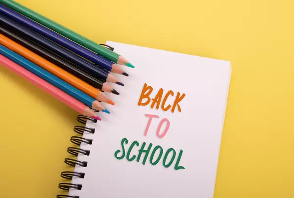 Colored pencils and notebook with Back to School text