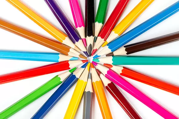 Colored pencils positioned in a circle with the tip towards the center