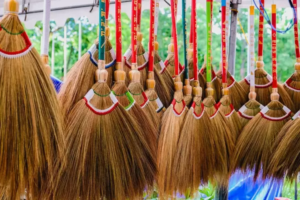 Colorful broomsticks for sale at a local market (Flip 2019)