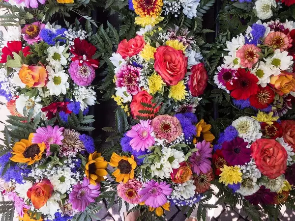 Colorful Bunches of Flowers hanging on a Wall