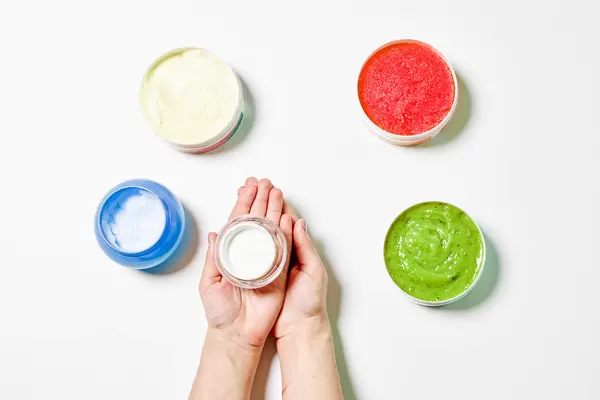 Colorful cosmetic creams containers made with herbs