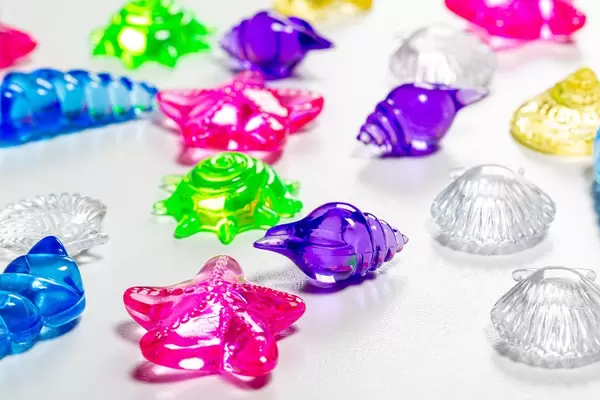 Colorful decor for aquarium in the form of seashells on a white background