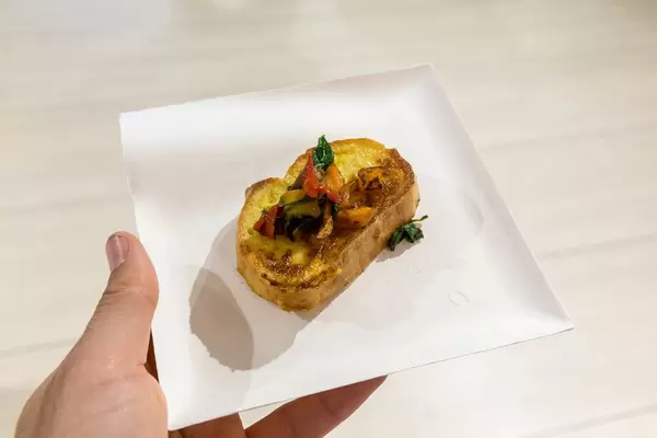 Colorful French Toast on a white plate in a man's hand