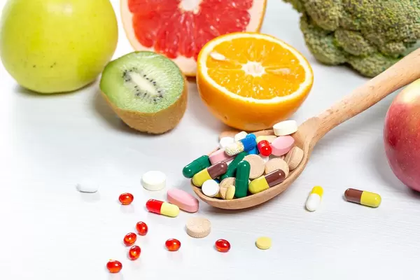 Colorful fruits and pills.The concept of vitamins in food and medicines