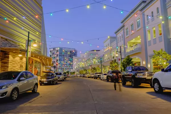 Colorful hanging lights shining across the street