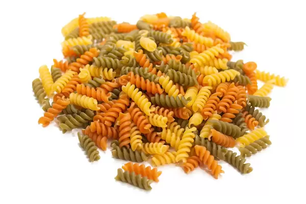 Colorful macaroni isolated above white background