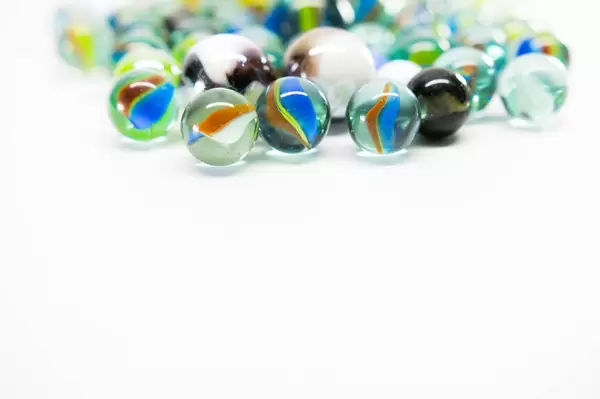Colorful marbles on a white surface