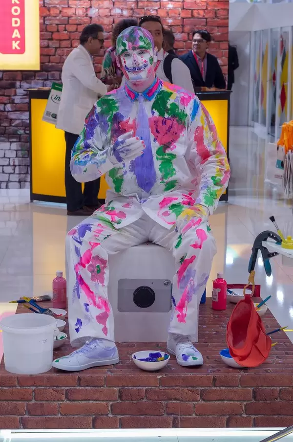 Colorful mime near Kodak's booth