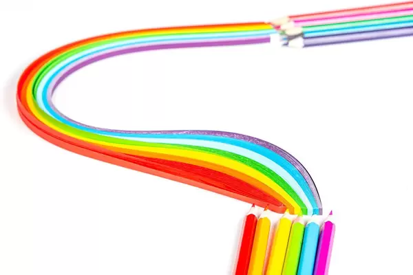 Colorful multicolored background with colored pencils and paper rainbow