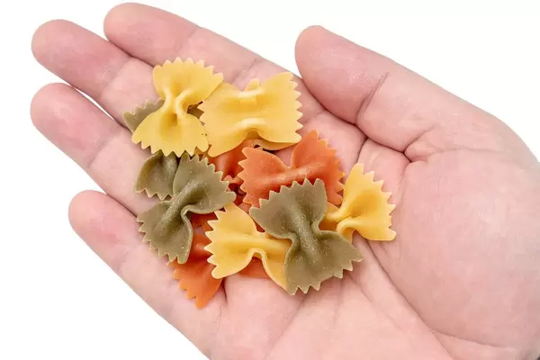 Colorful Pasta in Bow shape on the hand (Flip 2019)