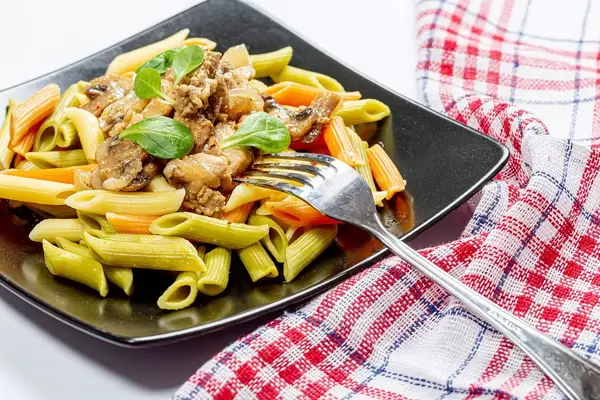 Colorful pasta with meat, mushrooms and fork (Flip 2019)