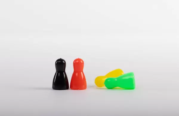 Colorful pawns isolated on white background