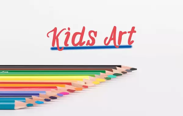 Colorful pencils on white background with text Kids Art