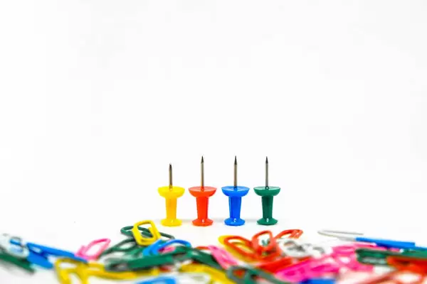 Colorful pins with paperclips on foreground