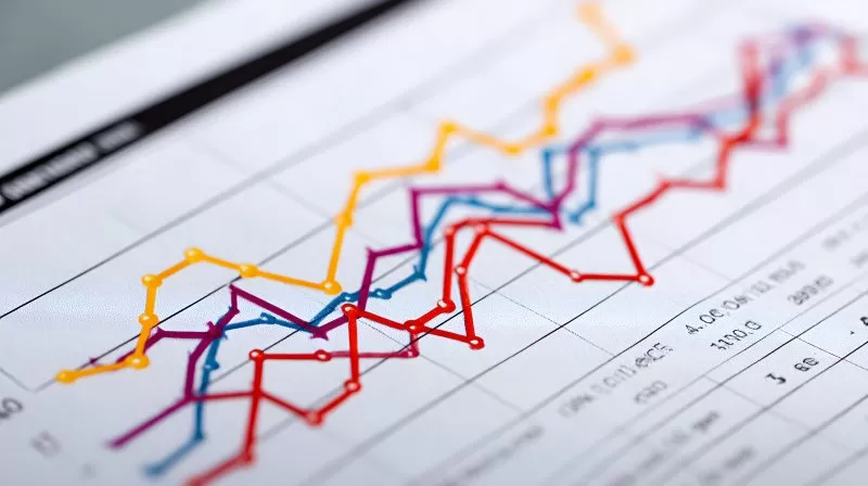Colorful rising line chart on printed paper shows financial growth