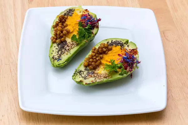 Colourful Avocado with pumpkin humus, lentils, chia and herbs