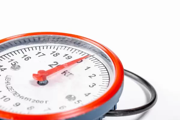 Compact mechanical scales on a white background close-up
