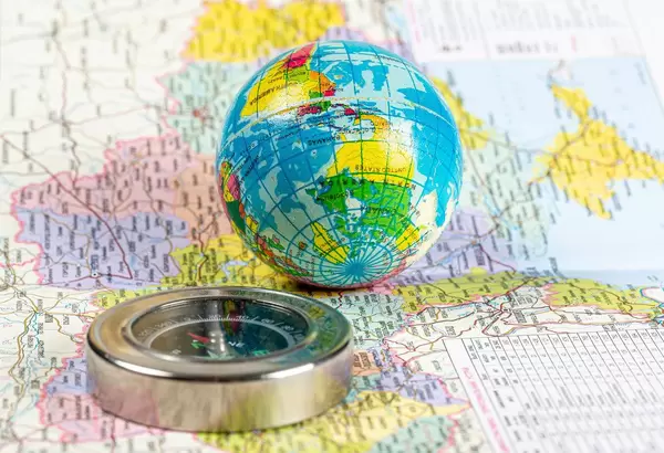 Compass and globe on the map background