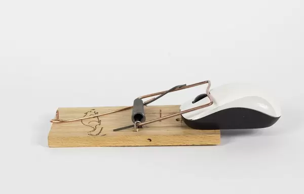 Computermaus gefangen in einer Mausefalle