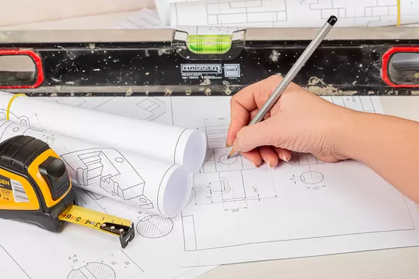Concept engineer work, holding pencil while working with drawings